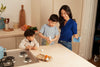 Blueland founder Sarah and her two young sons cleaning their kitchen counter
