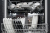 A loaded dishwasher of black and white plates