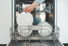 A dishwasher of clean plates being unloaded