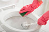 Cleaning toilet bowl with a toilet brush