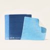 Three textured cleaning cloths are shown vertically. The top cloth is light blue with a folded corner showing a white underside, the middle is darker blue, and the bottom is navy. The brand Blueland is on the edges. Product: Cloud Cloth Subscription- 6pk.