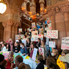 A group of protesters holding signs against plastic packaging